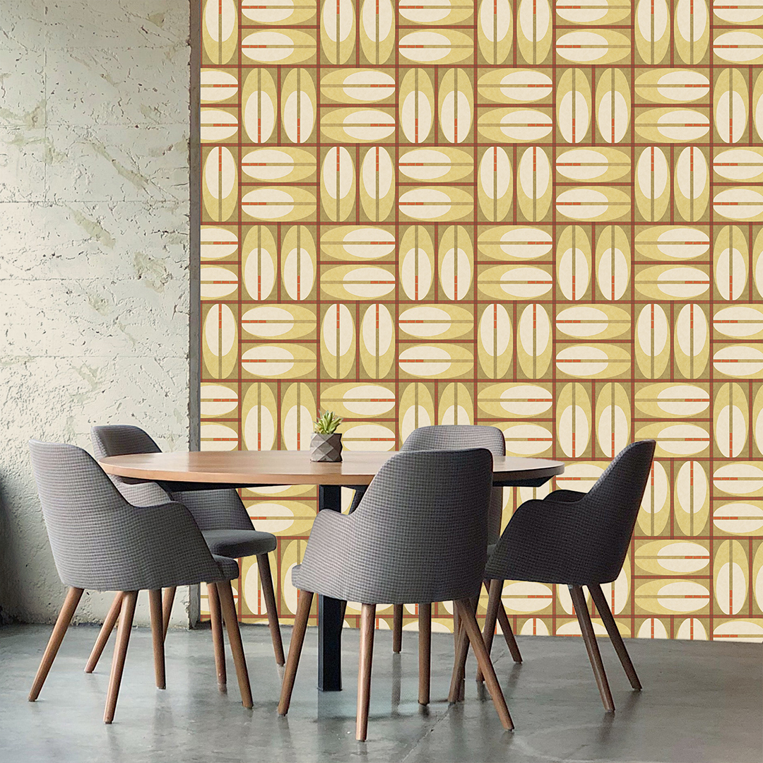 The artwork features a repeating geometric pattern of symmetrical shapes resembling elongated, curved diamonds or petals in various shades of blue and green. Each shape is split vertically with one half filled with a light blue and the other half filled with green or darker blue. The background is a light, almost pastel blue, which provides a soft yet vibrant backdrop. One of the blue shapes near the upper left contains a white starburst element, adding a focal point of brightness to the composition. The overall design conveys a modern, mid-century aesthetic with clean lines and harmonious color contrasts.